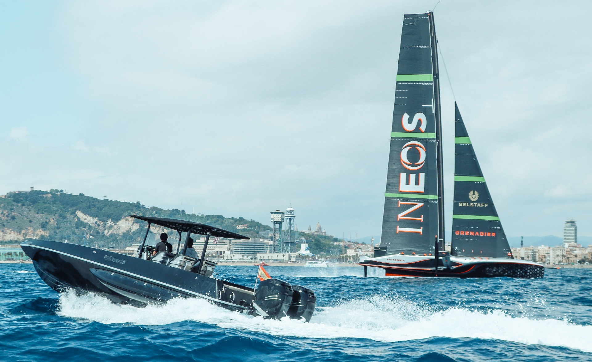 F11 powerboat running with the INEOS Britannia AC75 in the background