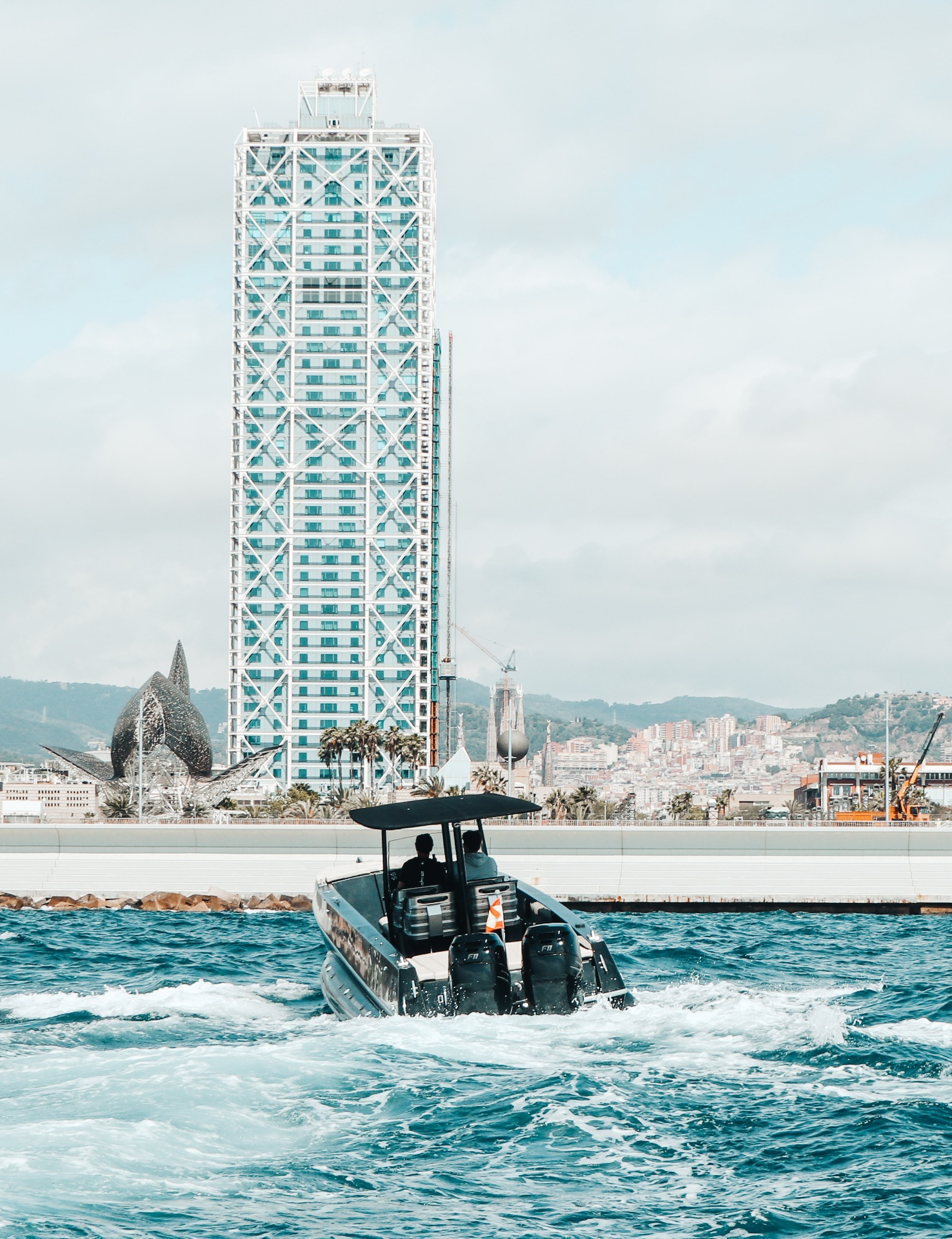 F11 returning past Hotel Arts and Frank Gehry fish, Barcelona