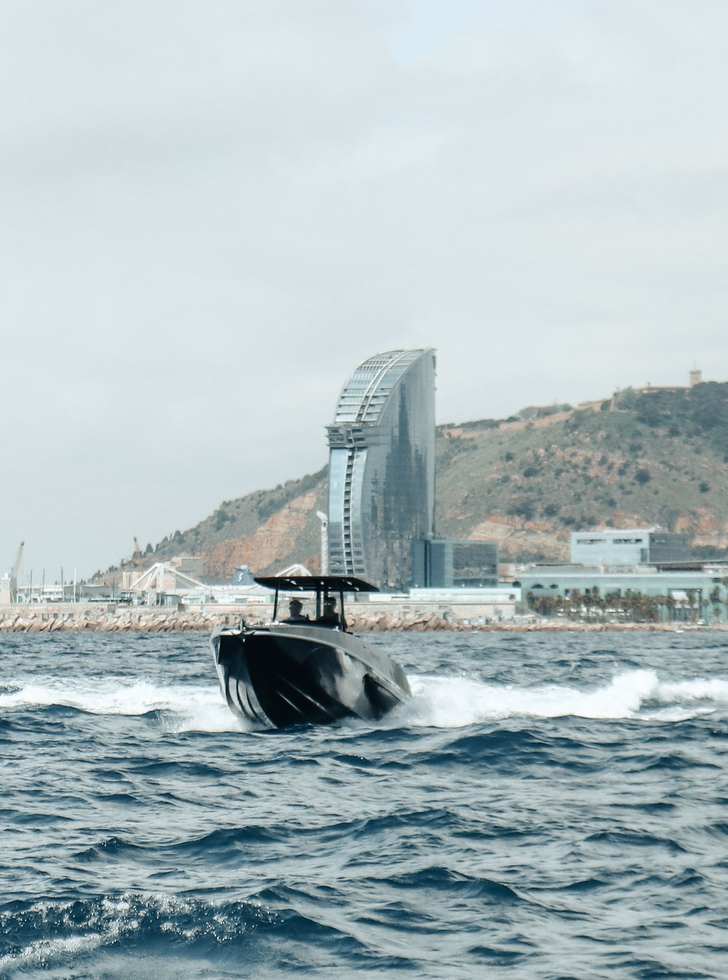 F11 running back into Barcelona past the W Hotel and Montjuïc